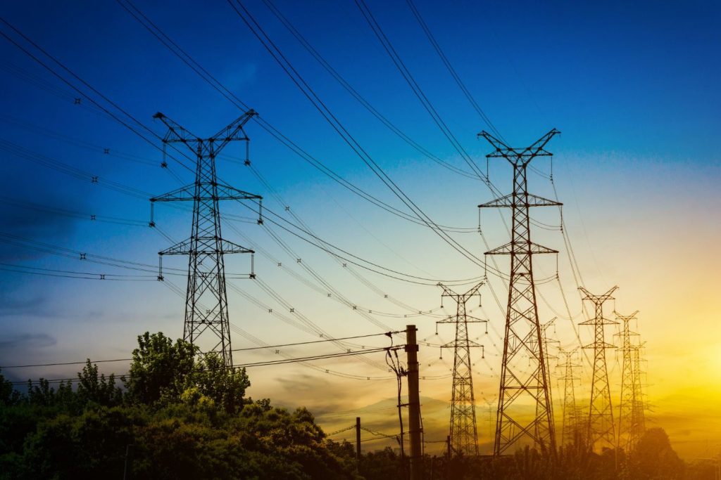 Pylons at dusk to illustrate a blog on satellite solutions for IELCO
