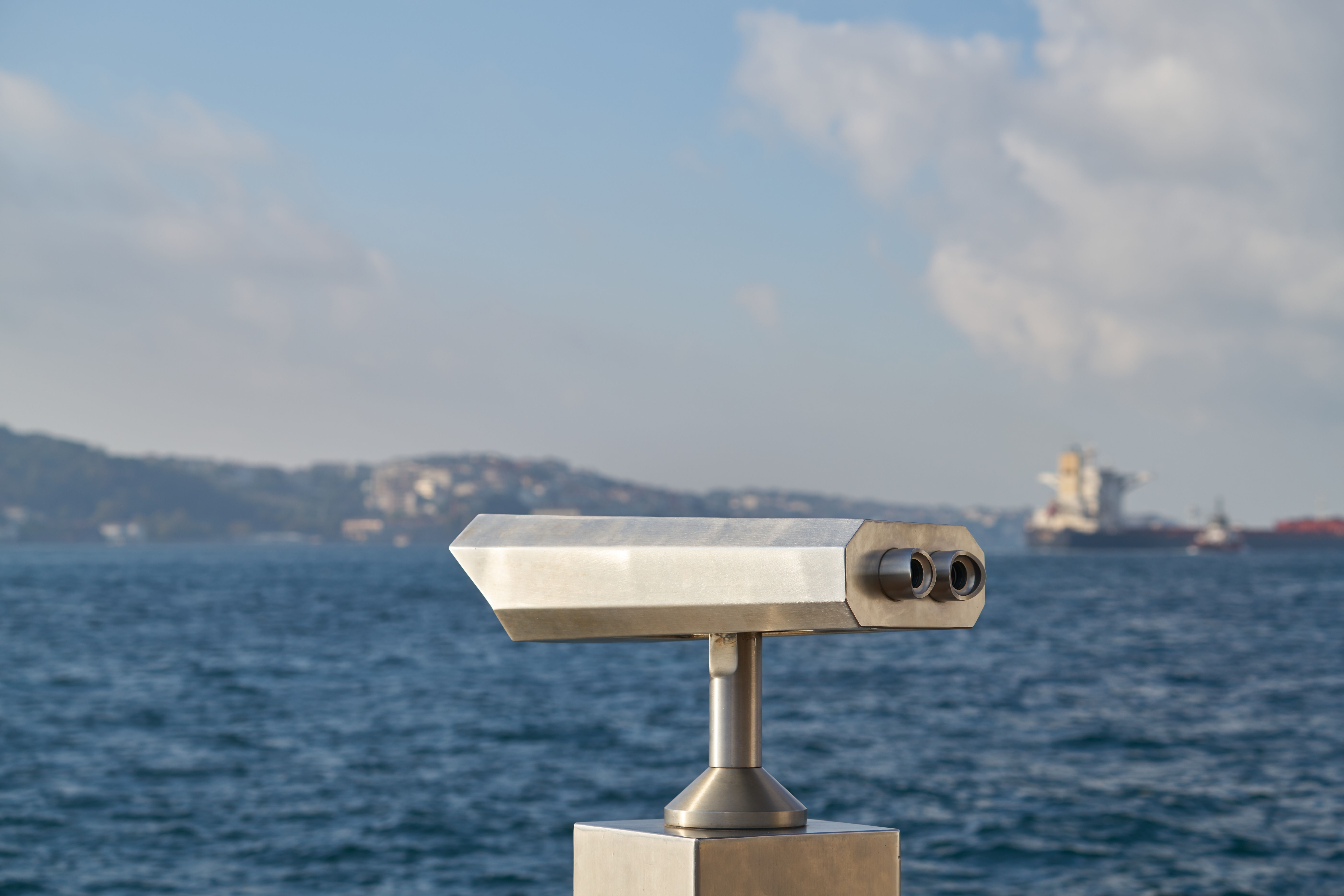 Image of binoculars at sea to depict monitoring assets remotely.