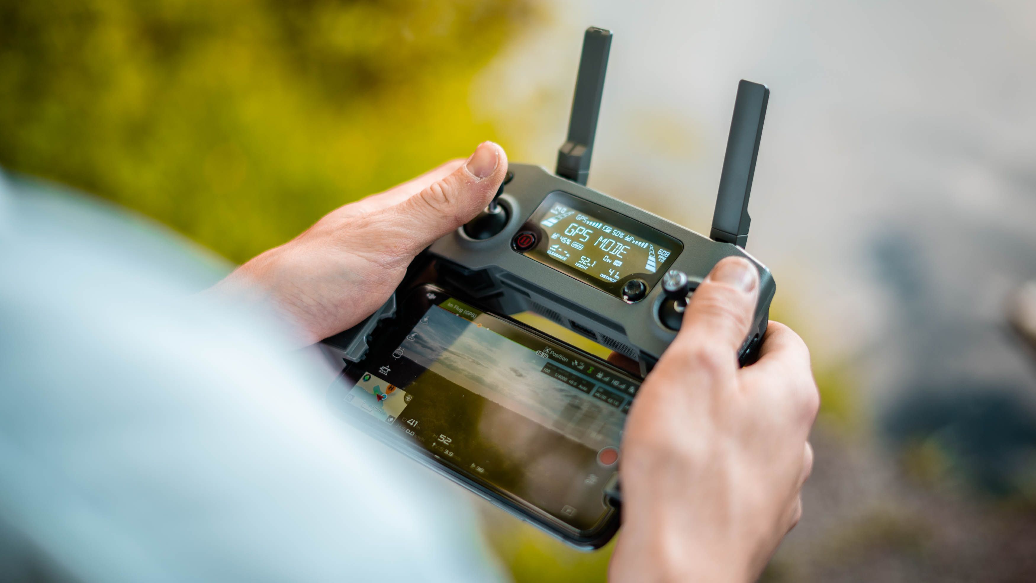 Picture of person operating a remote control to demonstrate remote asset management in satellite technology.