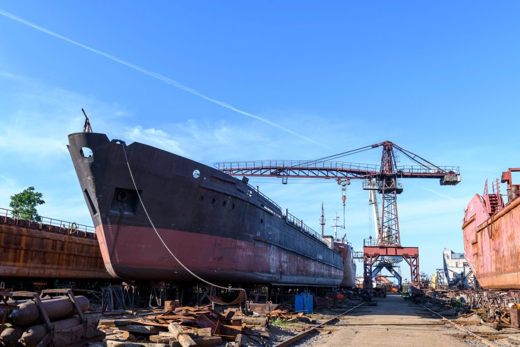 Boat in drydock in for repairs to illustrate the importance of planned maintenance systems for ships