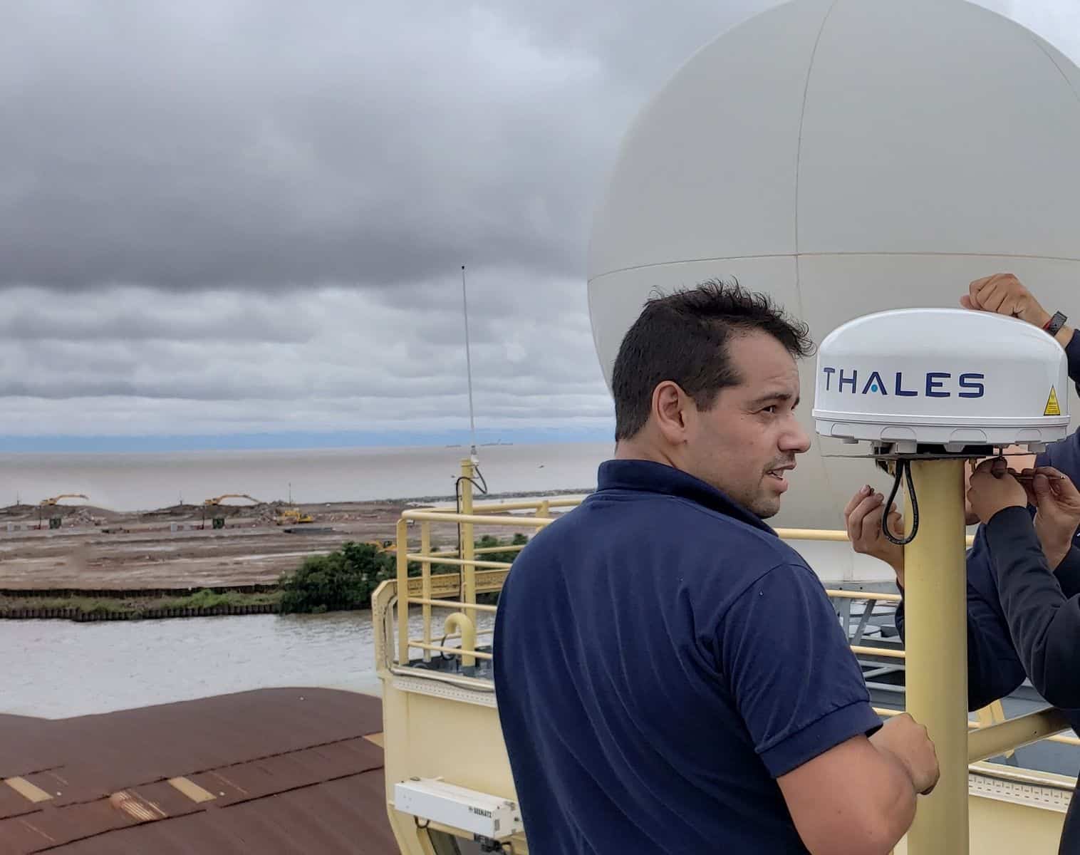 Photo of engineers installing Thales satellite hardware